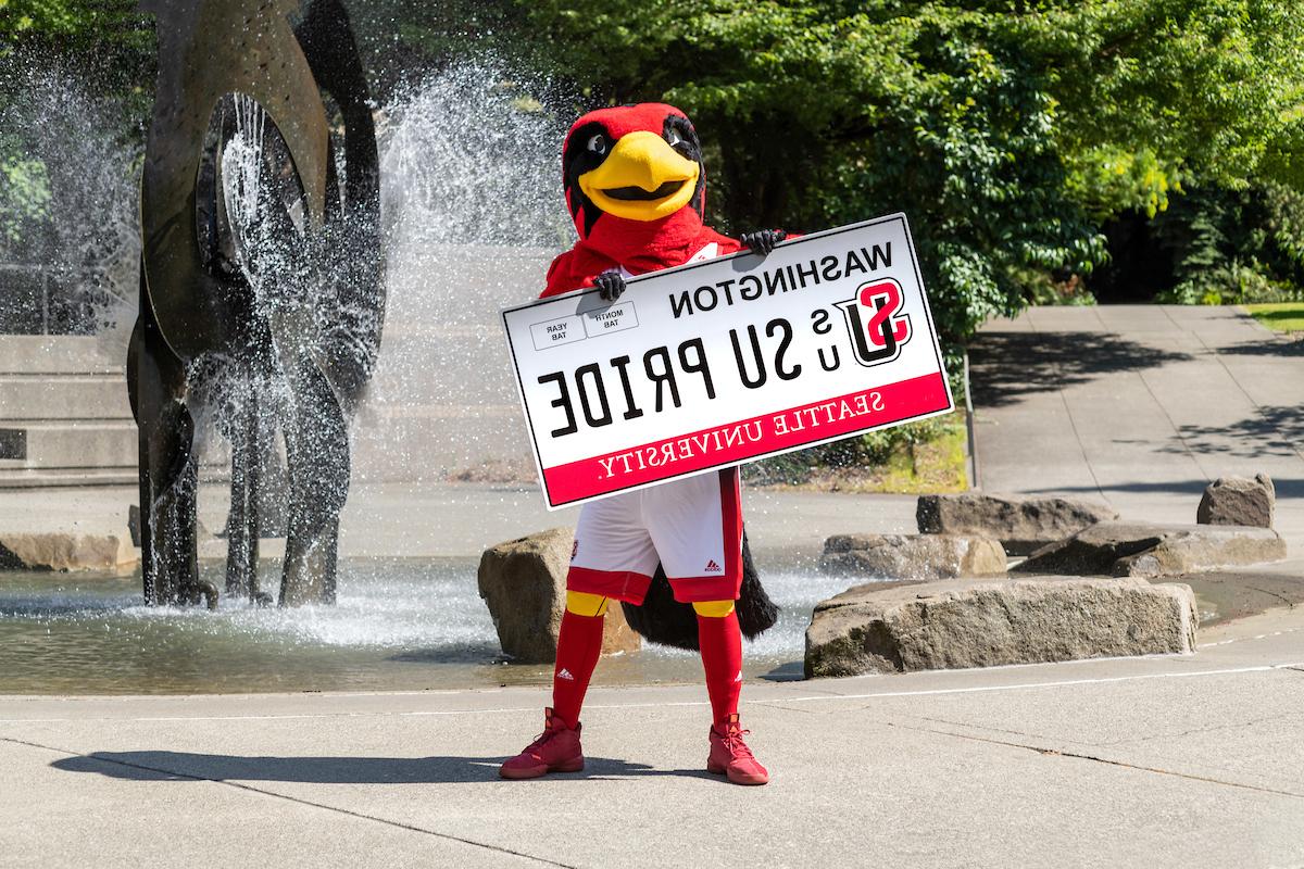 Rudy holding an SU Pride License Plate